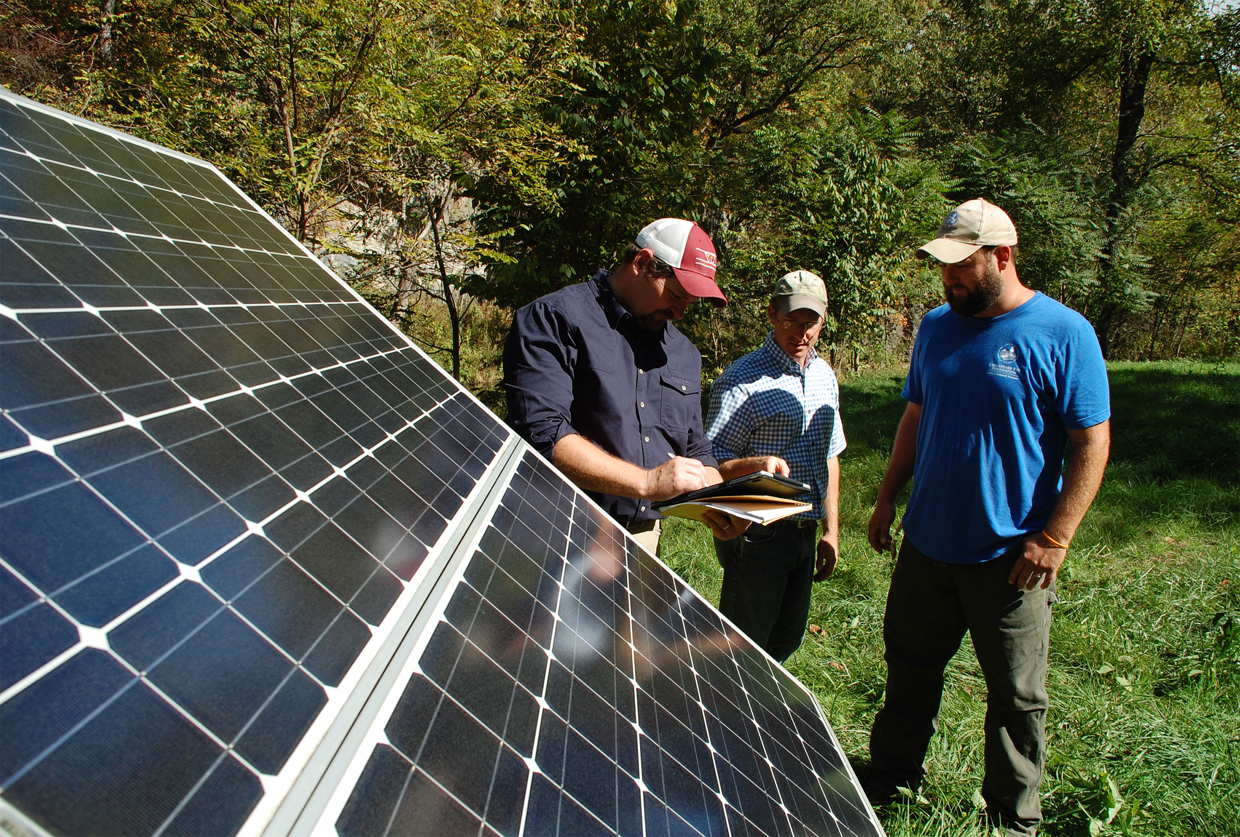 Extension Specialist John Ignosh and Extension Agent Matt Booher work with Alston Horn of the Chesapeake Bay Foundation to install solar-powered water stations that help protect the watershed. Photo by Kenny Fletcher, Chesapeake Bay Foundation.